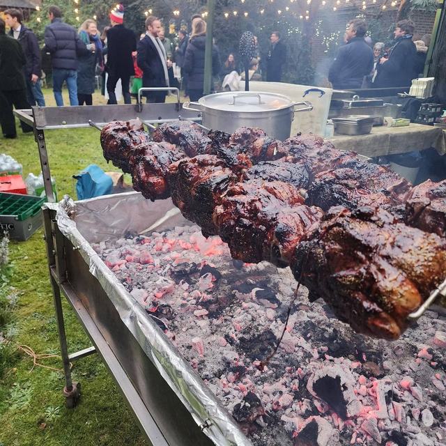 A Christmas party roast under festoon lights