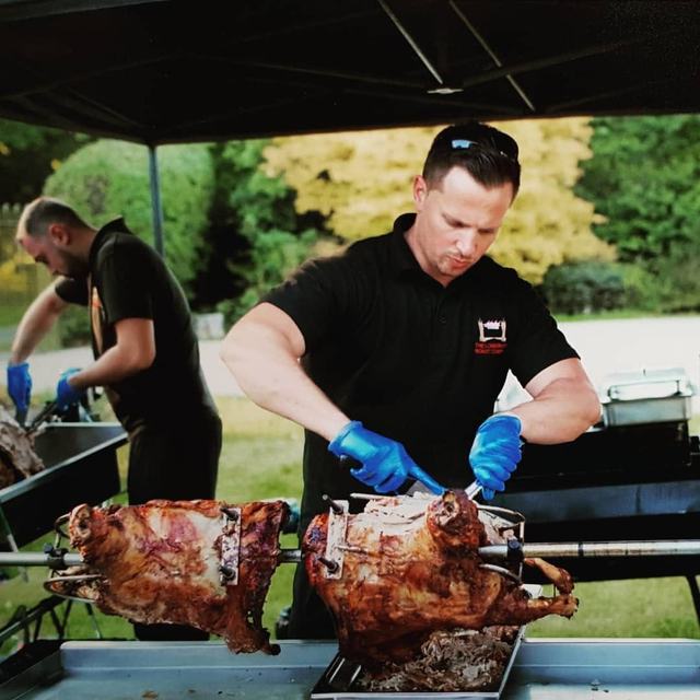 Carving charcoal-roasted suckling pigs