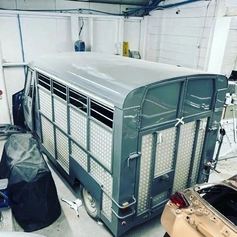 The van’s body sprayed grey inside the paint shop